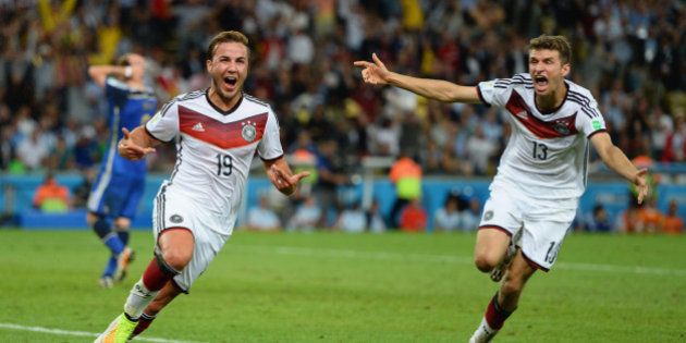 RIO DE JANEIRO, BRAZIL - JULY 13: Mario Goetze of Germany (L) celebrates scoring his team's first goal with Thomas Mueller during the 2014 FIFA World Cup Brazil Final match between Germany and Argentina at Maracana on July 13, 2014 in Rio de Janeiro, Brazil. (Photo by Jamie McDonald/Getty Images)
