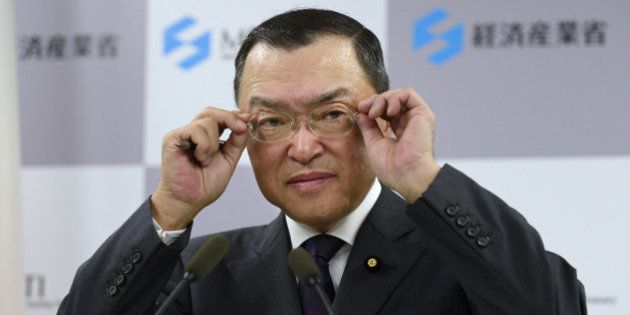 Yoichi Miyazawa, Japan's new trade and industry minister, adjusts his glasses during a news conference in Tokyo, Japan, on Tuesday, Oct. 21, 2014. Japanese Prime Minister Shinzo Abe rushed to appoint two new members of his cabinet yesterday, after two female ministers were forced to resign as he confronts some of the most difficult decisions since he took office. Photographer: Akio Kon/Bloomberg via Getty Images