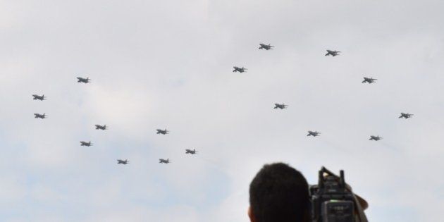 Military jet planes perform a flying formation of the number '60' to commemorate the 60th anniversary of Japan Self-Defense Forces Day -- the Military of Defense 60th Anniversary Air Review 2014 -- at the Hyakuri air base in Omitama, Ibaraki prefecture on October 26, 2014. 80 military aircrafts, 25 vehicles and 740 troops participated in the air review. AFP PHOTO / KAZUHIRO NOGI (Photo credit should read KAZUHIRO NOGI/AFP/Getty Images)