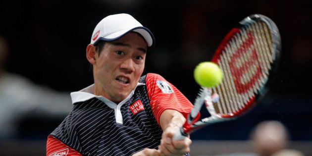 PARIS, FRANCE - OCTOBER 31: Kei Nishikori of Japan in action against David Ferrer of Spain in their quarterfinal match during day 5 of the BNP Paribas Masters held at the at Palais Omnisports de Bercy on October 31, 2014 in Paris, France. (Photo by Dean Mouhtaropoulos/Getty Images)