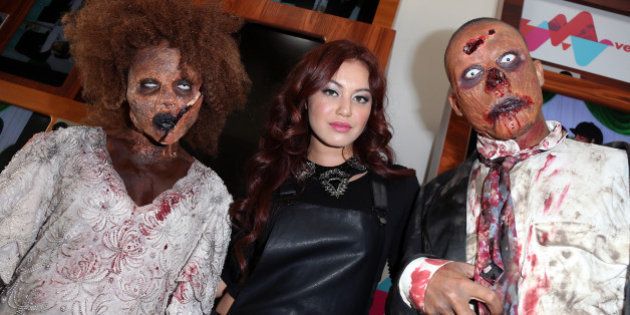 LOS ANGELES, CA - OCTOBER 31: VEVO Singer Guinevere (C) poses with two 'zombies' at her live performance and meet & greet at VEVO headquarters on October 31, 2013 in Los Angeles, California. (Photo by David Livingston/Getty Images)