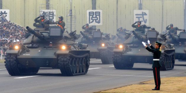 A tank unit takes part in an inspection parade at the Asaka base in suburban Tokyo on October 24, 2010. Around 3,800 personnel, 240 armored vehicles and 60 aircraft participated in the inspection parade. AFP PHOTO/Kazuhiro NOGI (Photo credit should read KAZUHIRO NOGI/AFP/Getty Images)