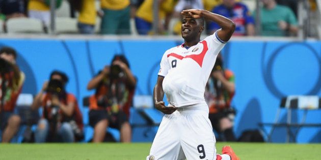 FORTALEZA, BRAZIL - JUNE 14: Joel Campbell of Costa Rica celebrates scoring his team's first goal with the ball under his jersey during the 2014 FIFA World Cup Brazil Group D match between Uruguay and Costa Rica at Castelao on June 14, 2014 in Fortaleza, Brazil. (Photo by Laurence Griffiths/Getty Images)