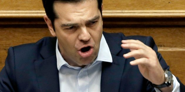 Greece's Prime Minister Alexis Tsipras delivers a speech to the lawmakers during an emergency Parliament session for the governmentâs proposed referendum in Athens, early Sunday, June 28, 2015. Greece's parliament has voted in favor of Prime Minister Tsipras' motion to hold a referendum on the country's creditor proposals for reforms in exchange for loans. Tsipras and his coalition government have urged people to vote against the deal, throwing into question the country's financial future.(AP Photo/Petros Karadjias)