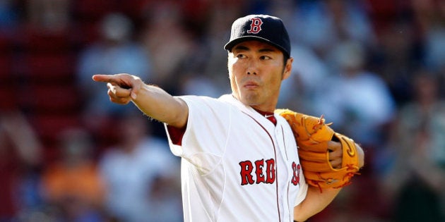 BOSTON, MA - JULY 6: Koji Uehara #19 of the Boston Red Sox reacts after picking off a base runner in...