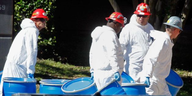 DALLAS, TX - OCTOBER 15: Hazmat workers with Protect Environmental unload barrels in preparation for decontaminating an apartment at The Village Bend East apartment complex where a second health care worker who has tested positive for the Ebola virus resides on October 15, 2014 in Dallas, Texas. Nurse Amber Vinson joins Nina Pham as health workers who have contracted the Ebola virus at Texas Heath Presbyterian Hospital while treating patient Thomas Eric Duncan, who has since died. (Photo by Mike Stone/Getty Images)