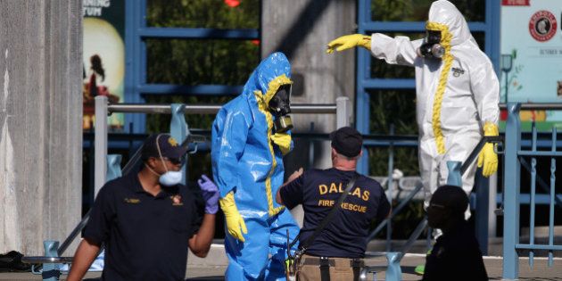 DALLAS, TX - OCTOBER 18: First responders wear full biohazard suits while responding to the report of a woman with Ebola-like symptoms at the Dallas Area Rapid Transit White Rock Station October 18, 2014 in Dallas, Texas. The woman reportedly lives in the same apartment complex as Thomas Eric Duncan, the Liberian who was the first patient diagnosed with Ebola in the United States, and who died on October 8. (Photo by Chip Somodevilla/Getty Images)