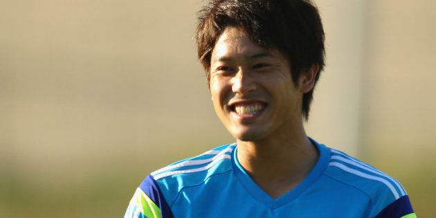 ITU, BRAZIL - JUNE 12: Atsuto Uchida laughs as he watches on during a Japan training session at the Japan national team base camp at the Spa Sport Resort on June 12, 2014 in Itu, Sao Paulo. (Photo by Mark Kolbe/Getty Images)