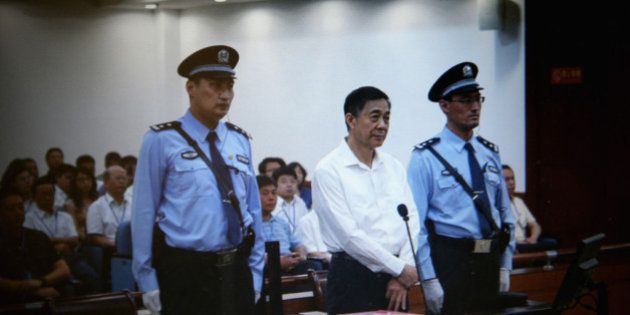 JINAN, CHINA - AUGUST 22: A screen shows the picture of the trial of disgraced Chinese politician Bo Xilai (Center) before a press conference in Jihua Hotel on August 22, 2013 in Jinan, China. Former Chinese politician Bo Xilai is standing trial on charges of bribery, corruption and abuse of power. Bo Xilai made global headlines last year when his wife wife Gu Kailai was charged and convicted of murdering British businessman Neil Heywood. (Photo by Feng Li/Getty Images)