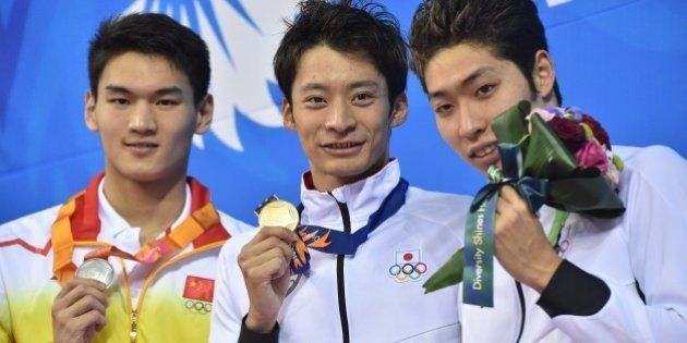 (L-R) Silver medallist China's Xu Jiayu, gold medallist Japan's Ryosuke Irie and bronze medallist Japan's Kosuke Hagino pose on the podium during the victory ceremony for the men's 200m backstroke swimming event during the 17th Asian Games at the Munhak Park Tae-hwan Aquatics Centre in Incheon on September 25, 2014. AFP PHOTO / PHILIPPE LOPEZ (Photo credit should read PHILIPPE LOPEZ/AFP/Getty Images)