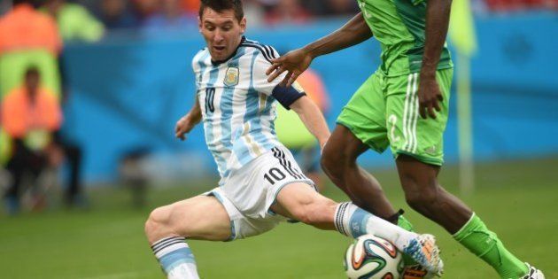 Argentina's forward Lionel Messi (L) vies for the ball with Nigeria's defender Kenneth Omeruo, during a Group F football match between Nigeria and Argentina at the Beira-Rio Stadium in Porto Alegre during the 2014 FIFA World Cup on June 25, 2014. AFP PHOTO / PEDRO UGARTE (Photo credit should read PEDRO UGARTE/AFP/Getty Images)