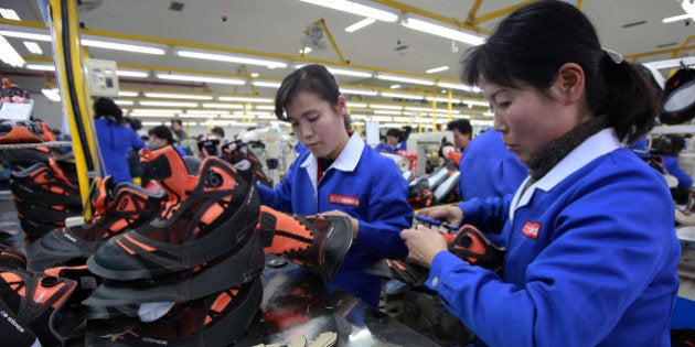 KAESONG, NORTH KOREA - DECEMBER 19: North Korean employees work at the assembly line of the factory of South Korean company at the Kaesong industrial complex on December 19, 2013 in Kaesong, North Korea. North Korea agreed on this rare cross-border trip of about 30 foreign officials and financial experts proposed by South Korea as the South Korean government watches on Pyongyang following the execution of leader Kim Jong-Un's uncle, Jang Song-Thaek. The Kaesong Industrial Complex was re-opened in September after a five-month closure caused by military tensions. (Photo by Park Jin-Hee-Pool/Getty Images)