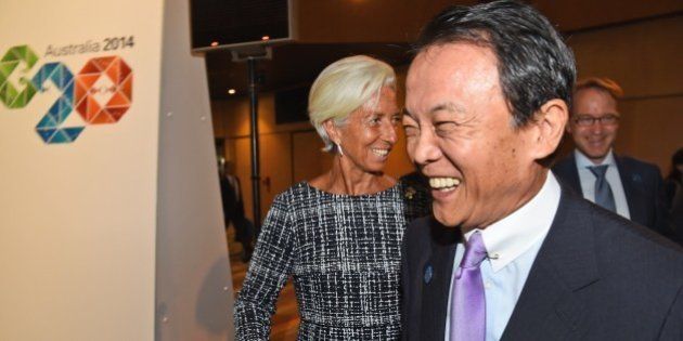 Head of the IMF Christine Lagarde (C) greets Japan's Minister of Finance Taro Aso (R) at the G20 Finance Ministers and Central Bank Governors Meeting in Cairns on September 20, 2014. Finance ministers from G20 nations meet in Cairns this weekend as they grapple with how to achieve a lift in global growth by two percent while being held back by a sickly eurozone recovery. AFP PHOTO/William WEST (Photo credit should read WILLIAM WEST/AFP/Getty Images)