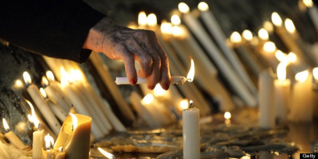 A woman lights a candle at the Basilica and National Sanctuary of Our Lady of Aparecida -which will be visited by Pope Francis Wednesday- in Aparecida, Sao Paulo state, Brazil on July 23, 2013. Pope Francis's popularity on his Latin American home turf posed a challenge to Brazilian authorities Tuesday after adoring crowds mobbed his car on his landmark visit during the World Youth day (WYD) to Rio de Janeiro. AFP PHOTO / NELSON ALMEIDA (Photo credit should read NELSON ALMEIDA/AFP/Getty Images)