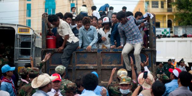 POIPET, CAMBODIA - JUNE 17: Cambodian workers get off a truck after crossing the Thai border on June 17, 2014 in Poipet, Cambodia. Over 150,000 Cambodian workers have reportedly fled Thailand this week, over fears the Thai government will crackdown on illegal migrants. (Photo by Borja Sanchez-Trillo/Getty Images)