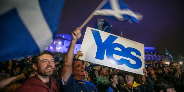 EDINBURGH, SCOTLAND - SEPTEMBER 17: Yes supporters gather outside the Scottish Parliament building on September 17, 2014 in Edinburgh, Scotland. The referendum debate has entered its final day of campaigning as the Scottish people prepare to go to the polls tomorrow to decide whether or not Scotland should have independence and break away from the United Kingdom. (Photo by Matt Cardy/Getty Images)