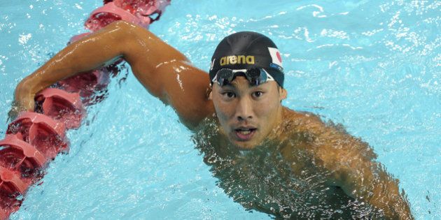Naoya Tomita of Japan looks at the scoreboard after competing in the men's 200-metre breaststroke during the FINA World Cup short-course swim in Singapore on November 4, 2011. Tomita won the gold medal. AFP PHOTO/ROSLAN RAHMAN (Photo credit should read ROSLAN RAHMAN/AFP/Getty Images)