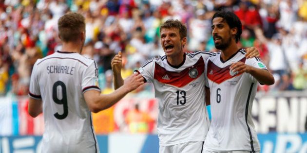 SALVADOR, BRAZIL - JUNE 16: Thomas Mueller of Germany (C) celebrates scoring his team's fourth goal and completing his hat trick with Andre Schuerrle (L) and Sami Khedira (R) during the 2014 FIFA World Cup Brazil Group G match between Germany and Portugal at Arena Fonte Nova on June 16, 2014 in Salvador, Brazil. (Photo by Phil Walter/Getty Images)