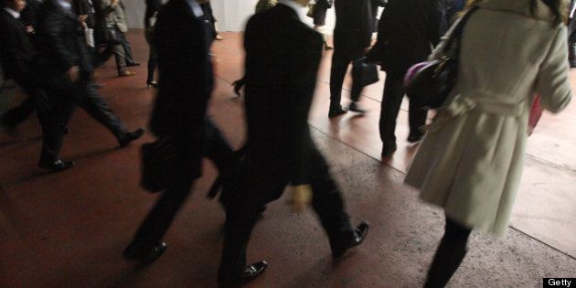 JAPAN - NOVEMBER 18: Business people walk into Tokyo station in Tokyo, Japan, on Tuesday, Nov. 18, 2008. Japan's economy will probably shrink this year and next in the first back-to-back contractions since the onset of the banking crisis a decade ago, economists say. (Photo by Tomohiro Ohsumi/Bloomberg via Getty Images)