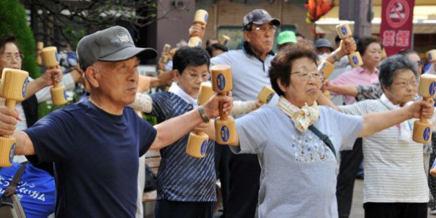 Elderly people work out with wooden dumb-bells in the grounds of a temple in Tokyo on September 17, 2012 to celebrate Japan's Respect-for-the-Aged-Day. The estimated number of people aged 65 or older topped a record high of 30.74 million in Japan, passing the 30 million threshold for the first time ever, the government announced. AFP PHOTO / Yoshikazu TSUNO (Photo credit should read YOSHIKAZU TSUNO/AFP/GettyImages)