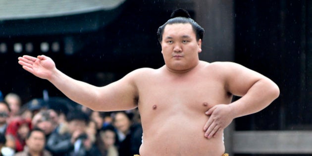 TOKYO, JAPAN - JANUARY 08: Sumo Grand Champion Hakuho Sho performs 'Dohyo-iri' (ring purification ritual) during Dezuiri ceremony at the Meiji Shrine on January 8, 2014 in Tokyo, Japan. It is a custom for Sumo Grand Champions to celebrate the new year by performing the ritual at the Meiji Jingu Shrine. (Photo by Keith Tsuji/Getty Images)