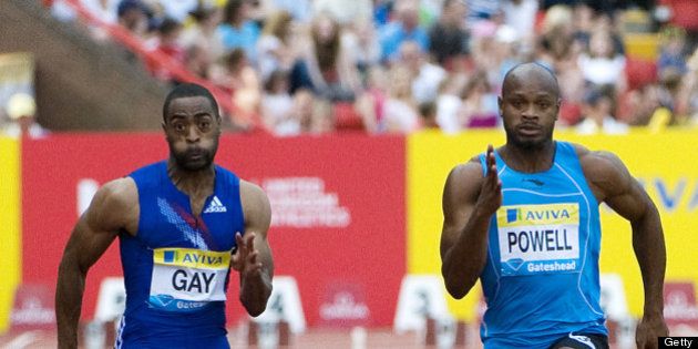 US Tyson Gay (L) runs to win the battle against Jamaica's Asafa Powell (R) in the mens 100m final at the Aviva British Grand Prix on July 10, 2010. AFP PHOTO/Derek Blair (Photo credit should read Derek Blair/AFP/Getty Images)