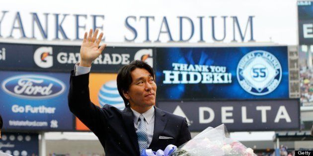 NEW YORK, NY - JULY 28: Former New York Yankee Hideki Matsui waves to the crowd during a pre game ceremony before a game against the Tampa Bay Rays as his father Masao looks on at Yankee Stadium on July 28, 2013 in the Bronx borough of New York City. (Photo by Jim McIsaac/Getty Images)