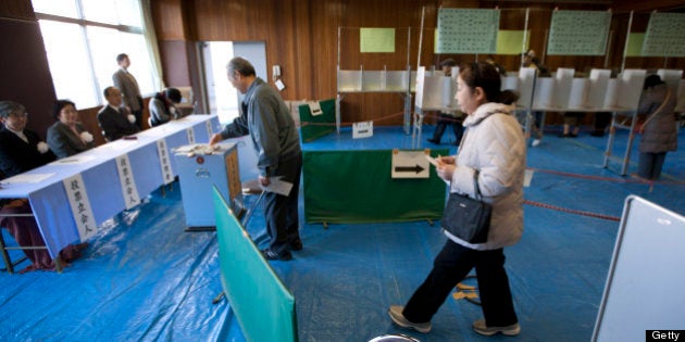 Voters cast their ballots at a polling station in Tokyo, Japan, on Sunday, Dec. 16, 2012. Japanese voters...