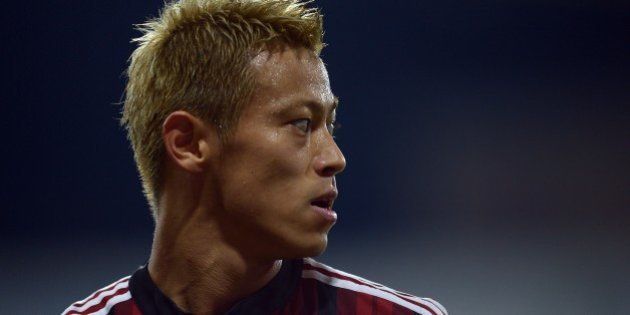 AC Milan's Japanese forward Keisuke Honda reacts during the Serie A football match at Parma's Ennio Tardini Stadium on September 14, 2014. AFP PHOTO/Filippo MONTEFORTE (Photo credit should read FILIPPO MONTEFORTE/AFP/Getty Images)