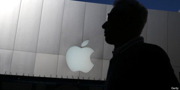 SAN FRANCISCO, CA - APRIL 23: A person walks by an Apple Store on April 23, 2013 in San Francisco, California. Analysts believe that Apple Inc. will report their first quarterly loss in nearly a decade as the company prepares to report first quarter earnings today after the closing bell. (Photo by Justin Sullivan/Getty Images)