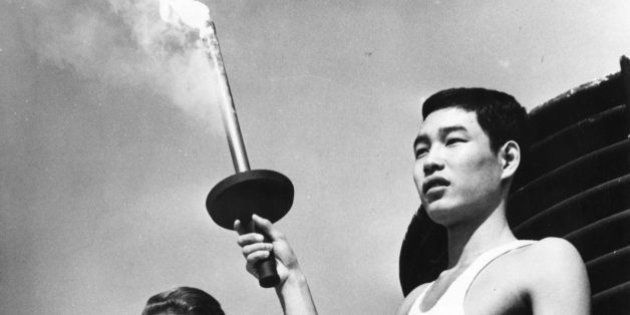 5th October 1964: Yoshinori Sakai, born at Hiroshima on the day the first atomic bomb was dropped on the city, holding the Olympic torch beside Greek actress Aleka Katseli during a rehearsal for the opening of the Olympic Games at Tokyo. (Photo by Central Press/Getty Images)