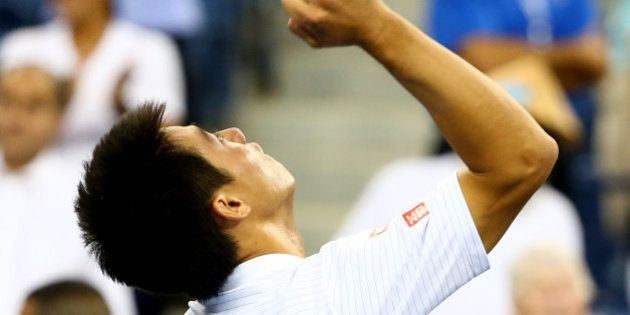 NEW YORK, NY - SEPTEMBER 03: Kei Nishikori of Japan celebrates after defeating Stan Wawrinka of Switzerland in their men's singles quarterfinal match on Day Ten of the 2014 US Open at the USTA Billie Jean King National Tennis Center on September 3, 2014 in the Flushing neighborhood of the Queens borough of New York City. Nishikori defeated Wawrinka in five sets 3-6, 7-5, 7-6, 6-7, 6-4. (Photo by Streeter Lecka/Getty Images)