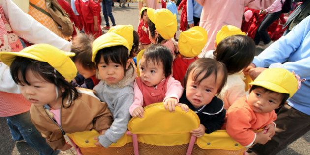 NAGOYA, JAPAN - NOVEMBER 09: Children from a nursery school gather at the Port of Nagoya to see the arrival...