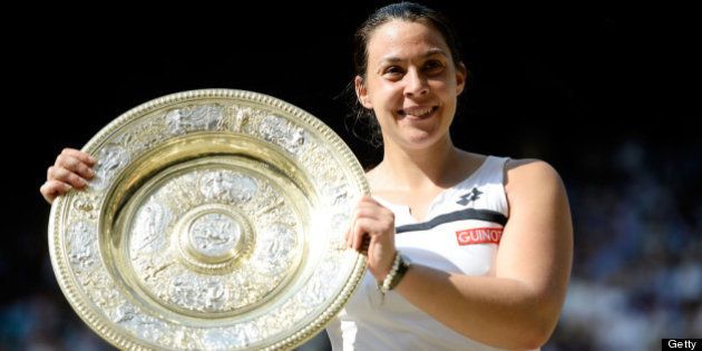 LONDON, ENGLAND - JULY 06: Marion Bartoli of France poses with the Venus Rosewater Dish trophy after her victory in the Ladies' Singles final match against Sabine Lisicki of Germany on day twelve of the Wimbledon Lawn Tennis Championships at the All England Lawn Tennis and Croquet Club on July 6, 2013 in London, England. (Photo by Dennis Grombkowski/Getty Images)
