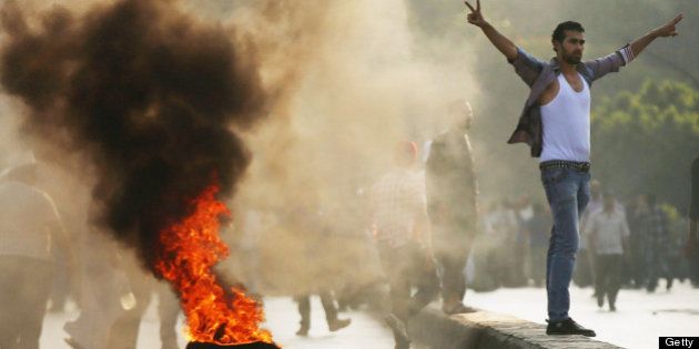 CAIRO, EGYPT - JULY 05: Supporters of former Egyptian President Mohammed Morsi burn tires along a bridge in protest over his removal by the Egyptian military on July 5, 2013 in Cairo, Egypt. Adly Mansour, chief justice of the Supreme Constitutional Court, was sworn in as the interim head of state in ceremony in Cairo in the morning of July 4, the day after Morsi was placed under house arrest by the Egyptian military and the Constitution was suspended. (Photo by Spencer Platt/Getty Images)