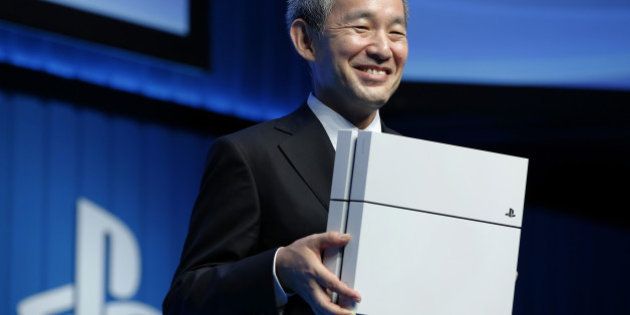 Atsushi Morita, president of Sony Computer Entertainment Japan Asia, holds a PlayStation 4 (PS4) games console as he poses for photographs during a news conference in Tokyo, Japan, on Monday, Sept. 1, 2014. Sony Corp. plans to offer 44 new games and updates for PlayStation Vita and PlayStation 4 in Japan, including Square Enix Holdings Co.'s Dragon Quest video-game series, according to Morita. Photographer: Kiyoshi Ota/Bloomberg via Getty Images