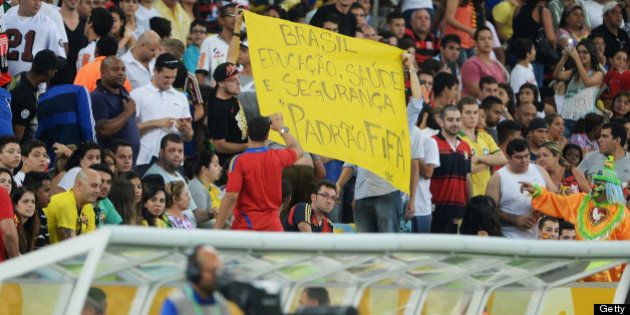 RIO DE JANEIRO, BRAZIL - JUNE 20: Protestors display banners during the FIFA Confederations Cup Brazil 2013 Group B match between Spain and Tahiti at the Maracana Stadium on June 20, 2013 in Rio de Janeiro, Brazil. (Photo by Michael Regan/Getty Images)
