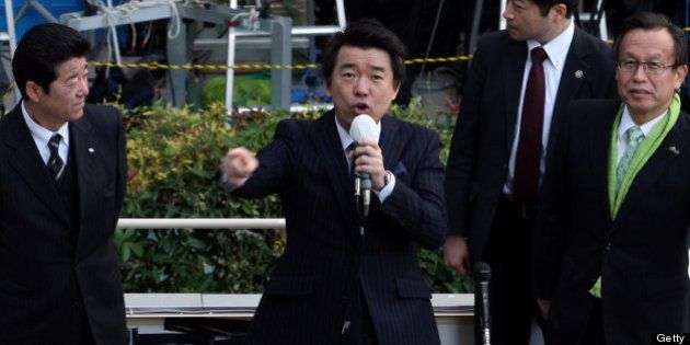 OSAKA, JAPAN - DECEMBER 04: Japan Restoration Party deputy leader Osaka Mayor Toru Hashimoto (C) speaks to voters during his official election party campaign for the upcoming lower house election on December 4, 2012 in Osaka, Japan. Japanese vote in the general election on December 16. (Photo by Buddhika Weerasinghe/Getty Images)