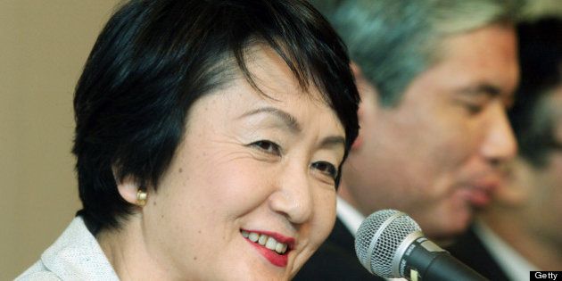 JAPAN - MARCH 30: Fumiko Hayashi, former president of BMW Japan Corp., left, smiles during a news conference in Tokyo, Japan Wednesday, March 30, 2005. It was announced that Hayashi will become an advisor to Daiei Inc., as of April 1, 2005. Yoshiaki Takahashi, newly appointed acting president of Daiei Inc., is seen at right. (Photo by Haruyoshi Yamaguchi/Bloomberg via Getty Images)