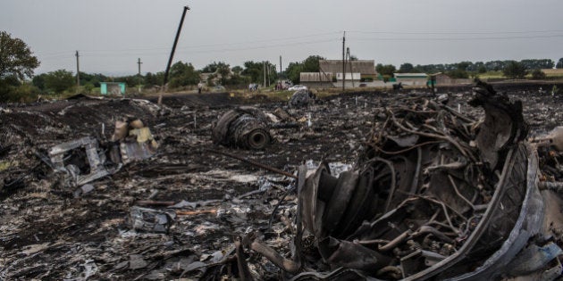 GRABOVKA, UKRAINE - JULY 18: Debris from an Malaysia Airlines plane crash lies in a field on July 18, 2014 in Grabovka, Ukraine. Malaysia Airlines flight MH17 travelling from Amsterdam to Kuala Lumpur crashed yesterday on the Ukraine/Russia border near the town of Shaktersk. The Boeing 777 was carrying 298 people including crew members, the majority of the passengers being Dutch nationals, believed to be at least 173, 44 Malaysians, 27 Australians, 12 Indonesians and 9 Britons. It has been speculated that the passenger aircraft was shot down by a surface to air missile by warring factions in the region. (Photo by Brendan Hoffman/Getty Images)