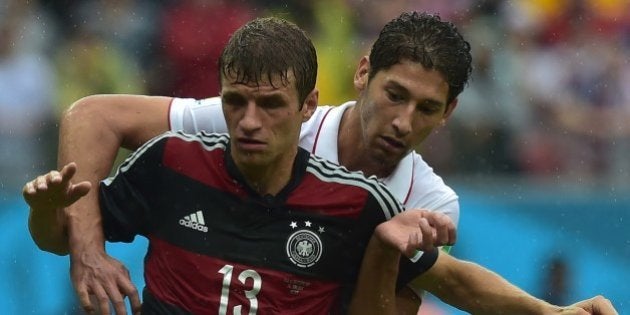 US defender Omar Gonzalez (R) and Germany's forward Thomas Mueller vie for the ball during a Group G football match between US and Germany at the Pernambuco Arena in Recife during the 2014 FIFA World Cup on June 26, 2014. AFP PHOTO / NELSON ALMEIDA (Photo credit should read NELSON ALMEIDA/AFP/Getty Images)