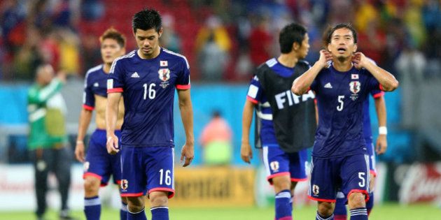 RECIFE, BRAZIL - JUNE 14: Hotaru Yamaguchi (L) and Yuto Nagatomo of Japan walk off the field after losing to the Ivory Coast 2-1 during the 2014 FIFA World Cup Brazil Group C match between the Ivory Coast and Japan at Arena Pernambuco on June 14, 2014 in Recife, Brazil. (Photo by Jamie Squire/Getty Images)