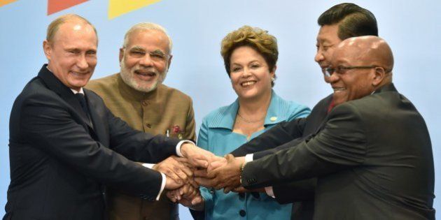 (L to R) Russia's President Vladimir Putin, India's Prime Minister Narendra Modi, Brazilian President Dilma Rousseff, China's President Xi Jinping and South Africa's President Jacob Zuma join their hands during the official photograph of the 6th BRICS summit in Fortaleza, Brazil, on July 15, 2014. Leaders of the BRICS (Brazil, Russia, India, China and South Africa) group of emerging powers gathered in Brazil on Tuesday to launch a new development bank and a reserve fund seen as counterweights to Western-led financial institutions. AFP PHOTO / NELSON ALMEIDA (Photo credit should read NELSON ALMEIDA/AFP/Getty Images)