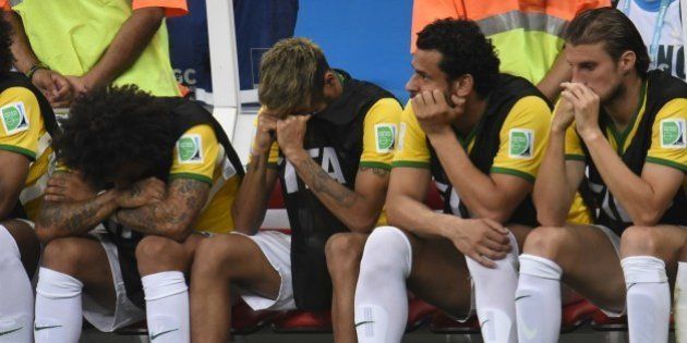 (L-R) Brazil's defender Marcelo, Brazil's injured forward Neymar, Brazil's forward Fred and Brazil's defender Henrique react on the bench at the end of the third place play-off football match between Brazil and Netherlands during the 2014 FIFA World Cup at the National Stadium in Brasilia on July 12, 2014. Netherlands won 3-0. AFP PHOTO / FABRICE COFFRINI (Photo credit should read FABRICE COFFRINI/AFP/Getty Images)