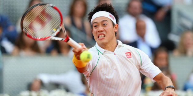 MADRID, SPAIN - MAY 11: Kei Nishikori of Japan plays a forehand against Rafael Nadal of Spain in their final match during day nine of the Mutua Madrid Open tennis tournament at the Caja Magica on May 11, 2014 in Madrid, Spain. (Photo by Clive Brunskill/Getty Images)