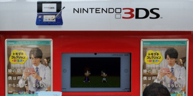 A pedestrian walks past an advertisement for Nintendo Co.'s 3DS handheld game console outside an electronics store in Tokyo, Japan, on Tuesday, April 23, 2013. Nintendo, the world's largest maker of video-game machines, will announce earnings on April 24. Photographer: Tomohiro Ohsumi/Bloomberg via Getty Images