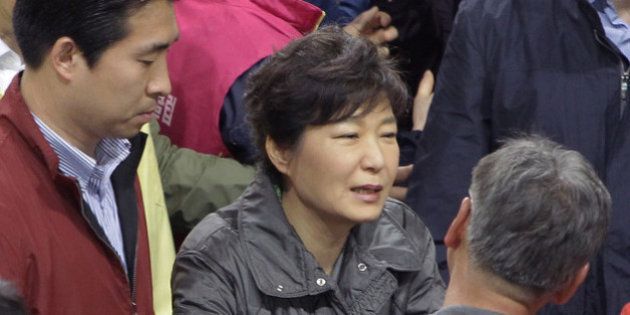 JINDO-GUN, SOUTH KOREA - APRIL 17: South Korean President Park Geun-Hye talks with relatives of missing passengers of a sunken ferry at Jindo gymnasium on April 17, 2014 in Jindo-gun, South Korea. Six are dead, and 290 are missing as reported. The ferry identified as the Sewol was carrying about 470 passengers, including the students and teachers, traveling to Jeju Island. (Photo by Chung Sung-Jun/Getty Images)