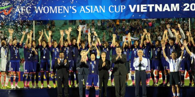 HO CHI MINH CITY, VIETNAM - MAY 25: Japan celebrates with the Asian Cup Trophy after they defeated Australia 1-0 during the AFC Women's Asian Cup Final match between Japan and Australia at Thong Nhat Stadium on May 25, 2014 in Ho Chi Minh City, Vietnam. (Photo by Stanley Chou/Getty Images)