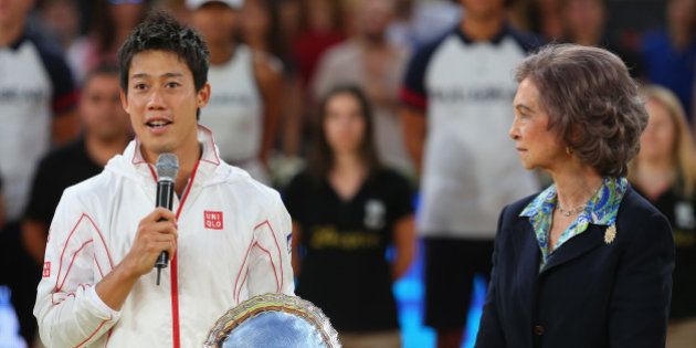 MADRID, SPAIN - MAY 11: Kei Nishikori of Japan makes his losers speach as Queen Sofia of Spain listens as he holds his runner up trophy after retiring injured in the third set against Rafael Nadal of Spain in their final match during day nine of the Mutua Madrid Open tennis tournament at the Caja Magica on May 11, 2014 in Madrid, Spain. (Photo by Clive Brunskill/Getty Images)
