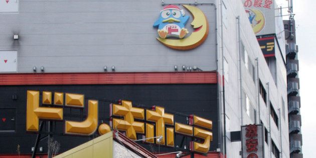 JAPAN - FEBRUARY 23: A shopper leaves a Don Quijote Co. Ltd. discount store in Tokyo, Thursday, February 23, 2006. (Photo by Haruyoshi Yamaguchi/Bloomberg via Getty Images)